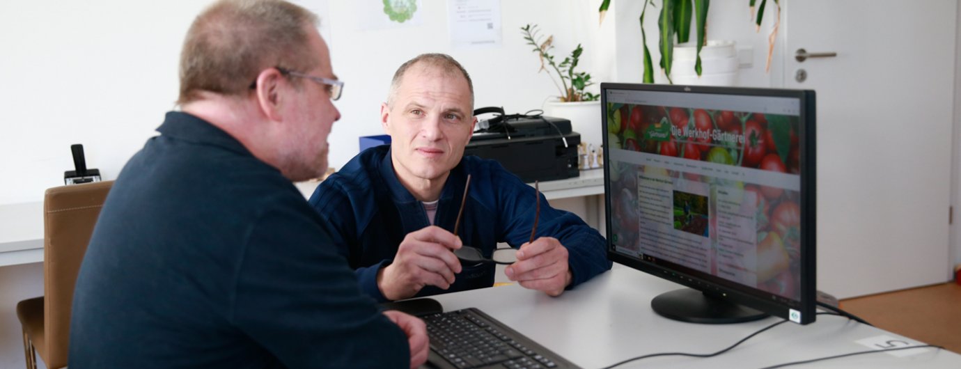 zwei Mänenr in eienr Beratungssituation an einem Computer